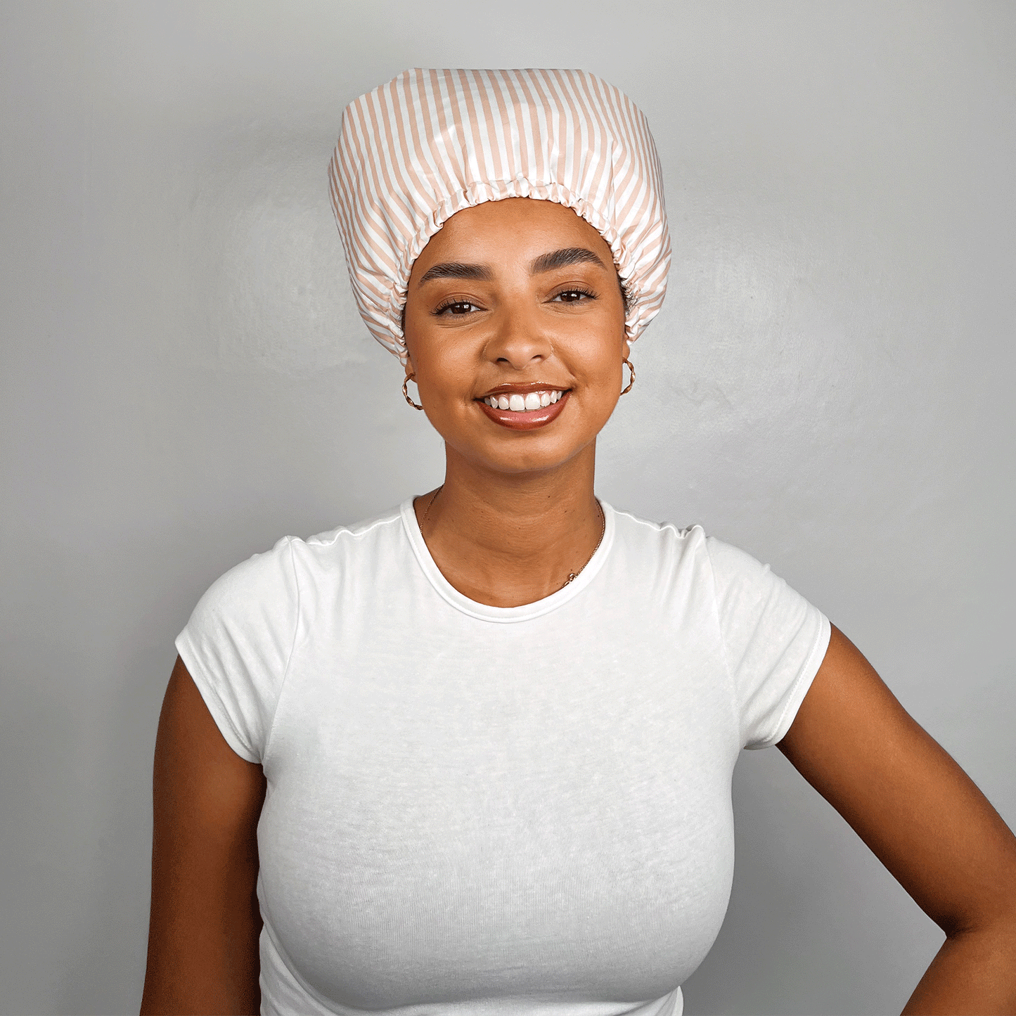 Culry hair model showing Bouclème satin lined shower cap