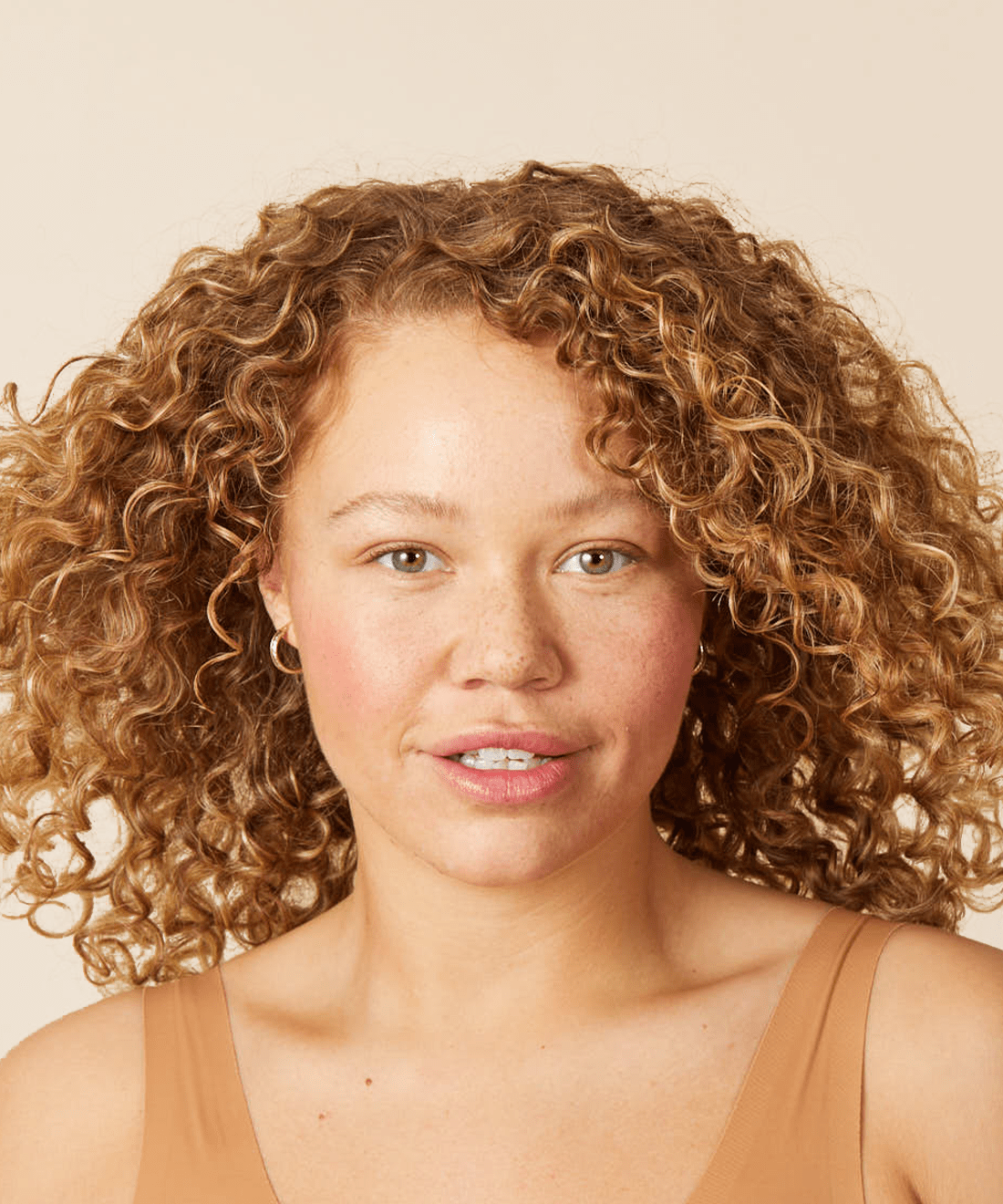 close up of a caucasian woman with strawberry blonde, curly hair