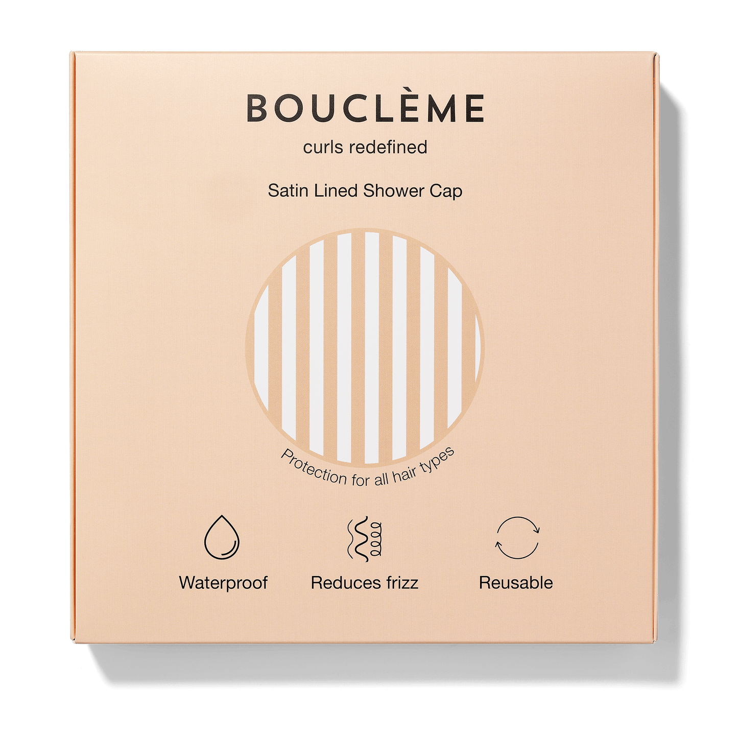 Bouclème satin-lined shower cap packaging on a beige background