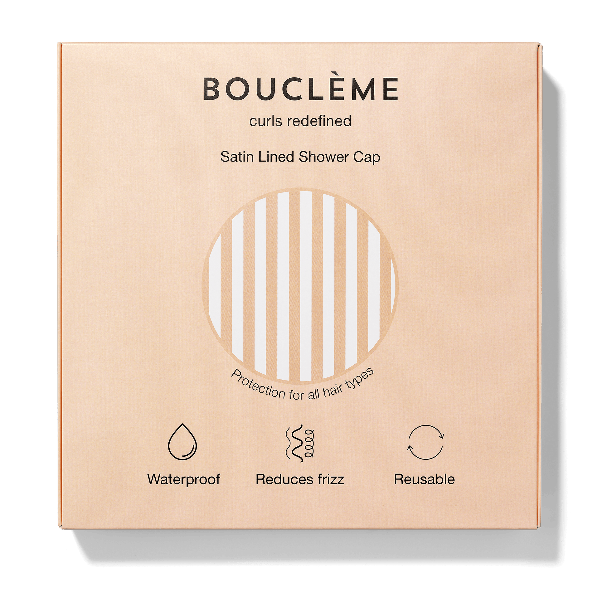 Bouclème satin-lined shower cap packaging on a beige background