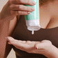 Model using Scalp Exfoliating Shampoo to detoxify scalp 