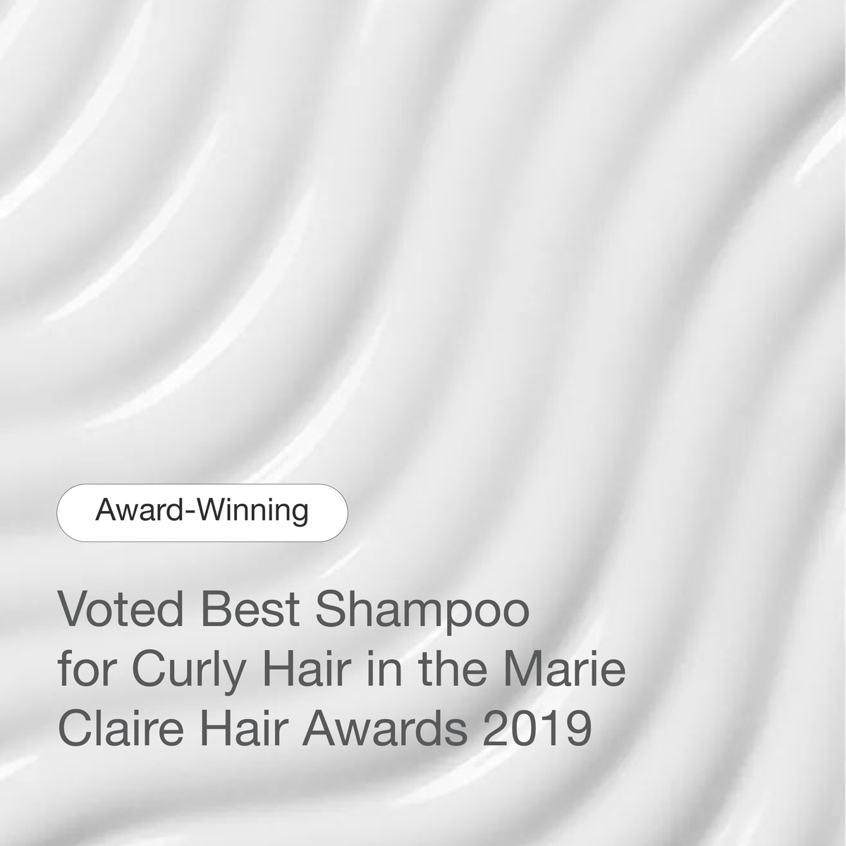Curl Cleanser cream texture. Text: Award-winning. Voted Best Shampoo for Curly Hair in the Marie Claire Hair Awards 2019